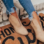 Beige V-cut ankle boots with soft suede finish and block heel, paired with cropped skinny jeans