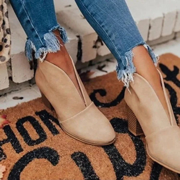 Beige V-cut ankle boots with soft suede finish and block heel, paired with cropped skinny jeans