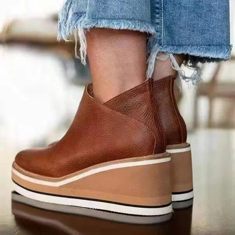Side profile of camel leather wedge ankle boot showing pebbled grain texture and chunky sole
